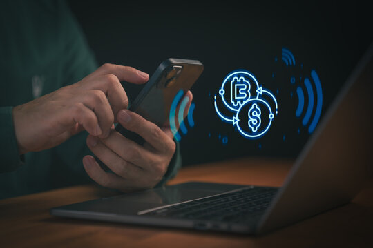 Man using smartphone for cryptocurrency exchange and digital finance transaction. Glowing crypto and dollar icon concept for mobile banking, internet investment, and futuristic financial technology.