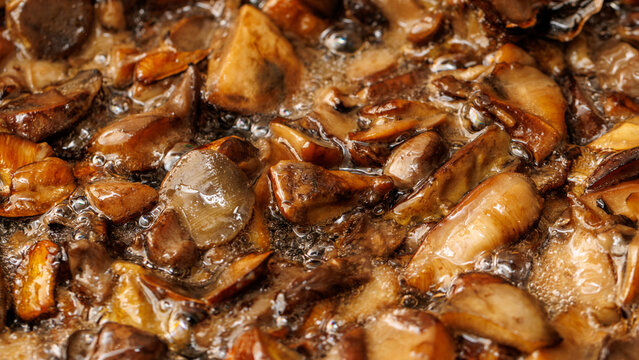 Crispy mushrooms simmer in rich, glossy sauce. Golden-brown edges hint at perfect sear. Texture contrasts invite bold culinary appreciation.