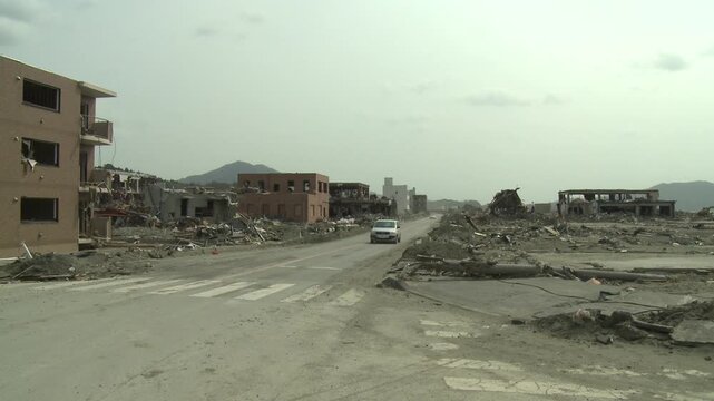 Car Drives Through Town Wiped Out In Aftermath Of Tsunami In Japan
