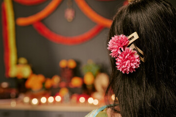 Obraz premium Rear view of Indian woman wearing festive floral hair accessories during festival celebration. Image useful for cultural campaign, beauty marketing, holiday promotion