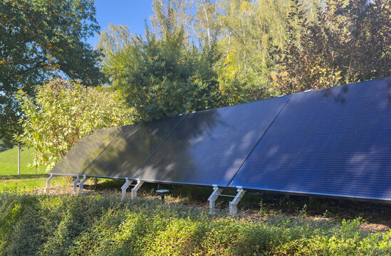 solar panels in a garden on the single-family house