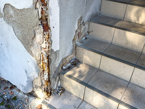 Old Staircase with Broken Tiles and Peeling Plaster