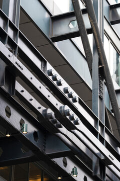 Metal beams and steel lines cross through an industrial structure where geometry and pattern define architecture across the construction detail