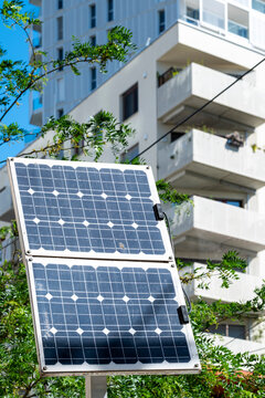 Solar panels beside a residential building in Vienna combine modern urban architecture with balconies and greenery across the facade