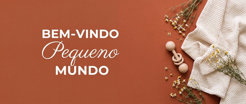 Baby shower flat lay background with wooden rattle, waffle blanket, chamomile flowers, and Portuguese text Bem Vindo Pequeno Mundo on terracotta surface for newborn arrival banner and copy space.