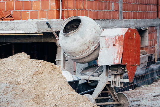 Cement mixer with worn drum texture at an active building construction site - ideal for contractor and industry