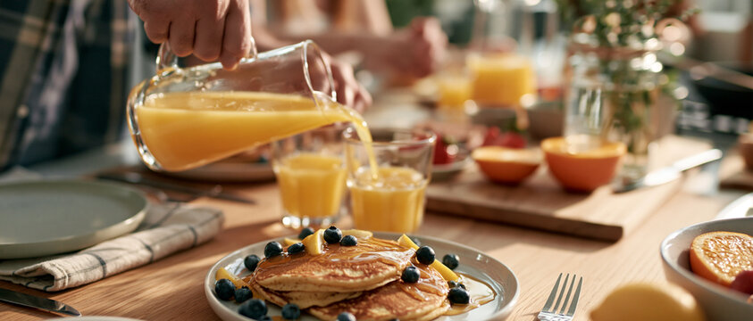 Morning Breakfast Table Spread with Pancakes and Juice