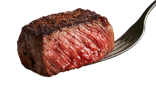 Medium rare grilled beef steak cube on a silver metal fork