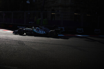 Naklejka premium BAKU, AZERBAIJAN - SEPTEMBER 2026: A Mercedes-AMG F1 car navigates a sunlit section of the Baku City Circuit during the Formula 1 Azerbaijan Grand Prix 2026