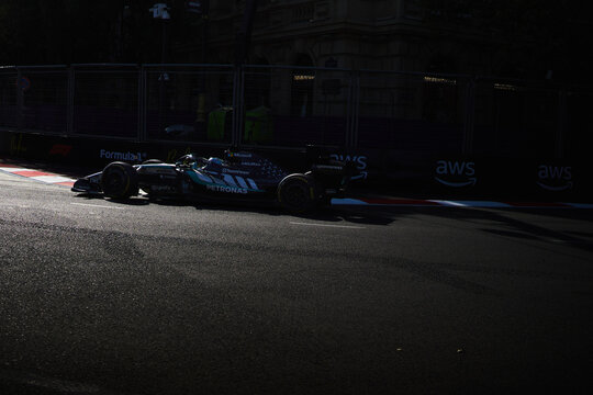 BAKU, AZERBAIJAN - SEPTEMBER 2026: A Mercedes-AMG F1 car navigates a sunlit section of the Baku City Circuit during the Formula 1 Azerbaijan Grand Prix 2026
