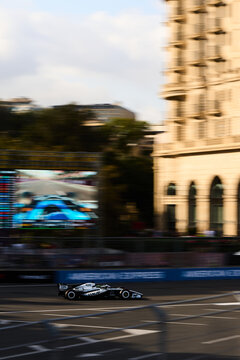 BAKU, AZERBAIJAN - SEPTEMBER 2026: A Cadillac F1 car races past the Four Seasons Hotel and a trackside screen during the Formula 1 Azerbaijan Grand Prix 2026