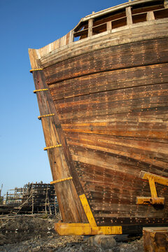 Ship hull stern with yellow metal brackets, Mandvi, India