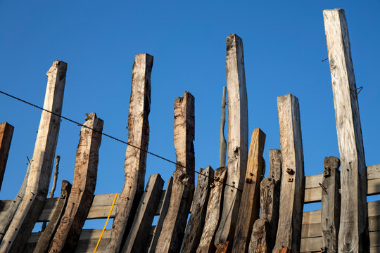 Wooden ship timbers rising against the sky, Mandvi, India