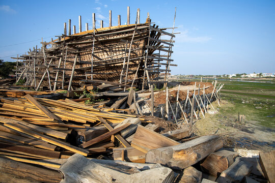 Wooden ship hull and timber logs, Mandvi, India