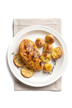 Oven roasted lemon garlic chicken and potatoes on plate