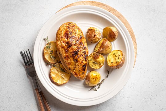 Oven roasted lemon garlic chicken and potatoes on plate