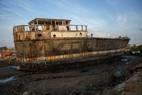 Sunset view of a decaying shipwreck hull, Mandvi, India