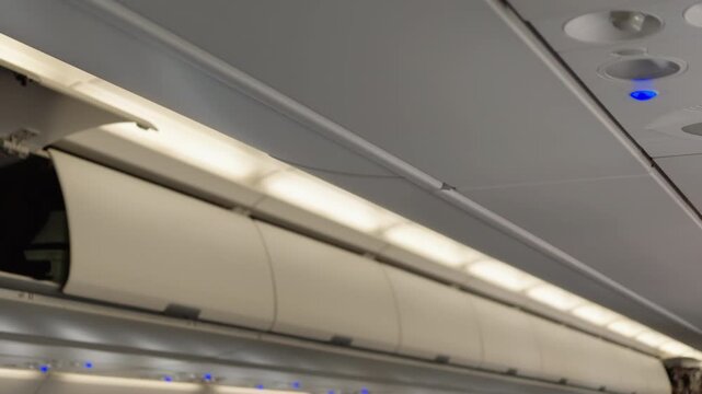 Passenger airplane overhead luggage compartment and cabin ceiling