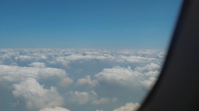 Aerial view of cloudscape from passenger airplane window