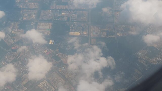 Clouds and distant landscape seen from airplane window