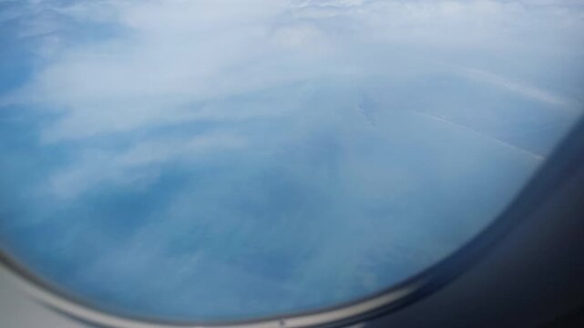Airplane engine and sky seen from passenger window