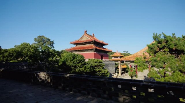 Historic Qing dynasty pavilion framed by pine trees at Zhaoling Tomb