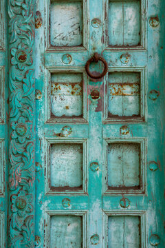 Turquoise door with a ring knocker, Mandvi, India