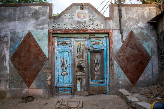 Weathered blue door with cat, Mandvi, India