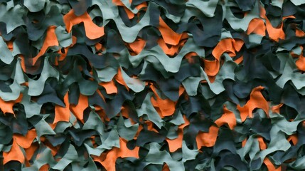 Fototapeta premium Camouflage netting pattern with green and orange fabric