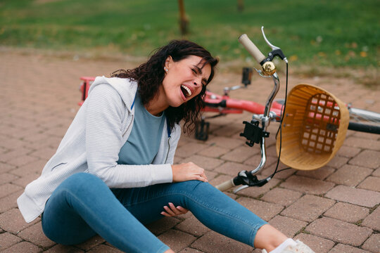 Woman experiencing pain after a bicycle accident