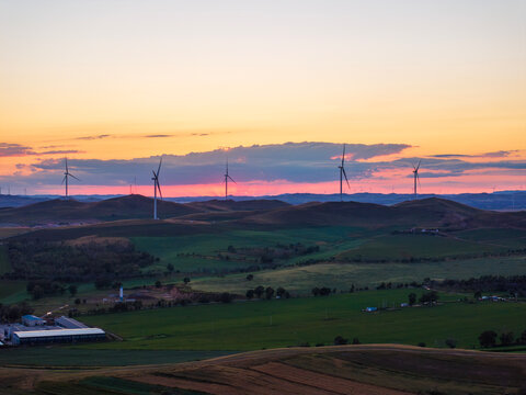 Wind Turbines Bathed in Golden Sunset Glow.