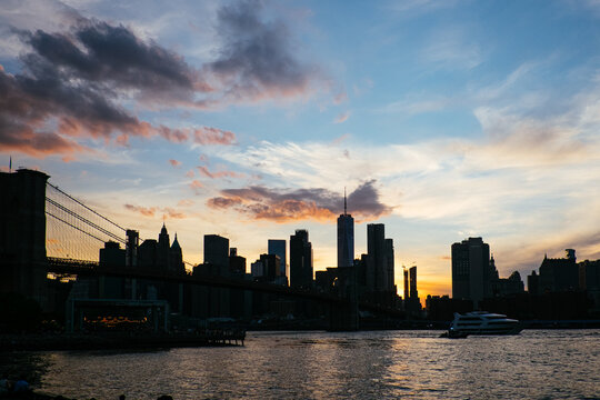 Brooklyn Bridge and Manhattan skyline at dusk over the East River in New York City, USA