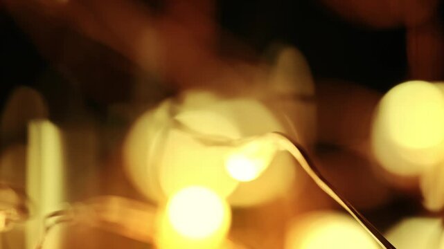 Close-up shot of glowing garland fairy lights creating soft golden bokeh orbs with warm ambient illumination.