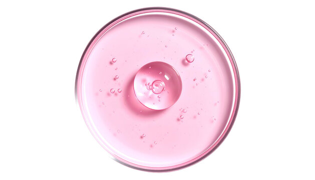 Pink liquid in petri dish with large droplet and small bubbles