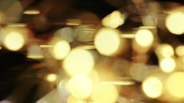 Macro shot of warm golden fairy lights creating soft bokeh circles and streaks with ambient illumination.
