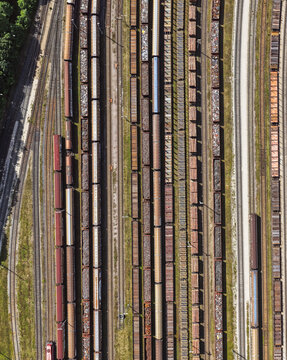 Aerial view of freight trains parked on parallel tracks in a railway yard in Saalfeld, Thuringia, Germany.
