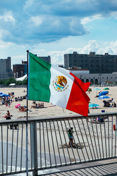 Mexican flag, people relaxing on Brighton Beach, Coney Island, Brooklyn, New York, USA. g2.