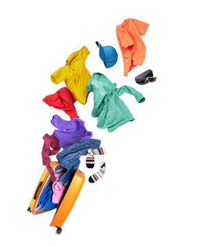 Colorful casual clothes flying out of an open orange suitcase on a white background