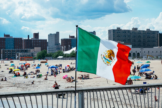 Mexican flag, people relaxing on Brighton Beach, Coney Island, Brooklyn, New York, USA. g2.