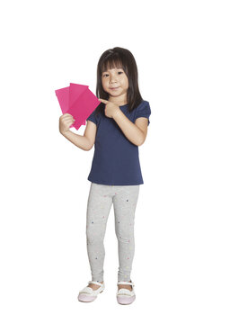 Asian child celebrating Lunar New Year holding red envelopes