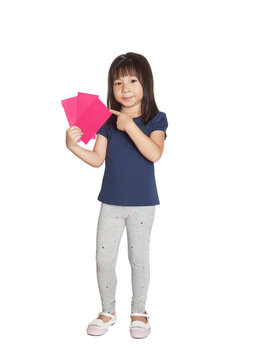 Asian child celebrating Lunar New Year holding red envelopes