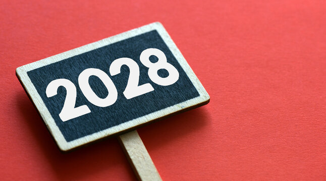 2028 on black sign with copy space on red background. New year business concept