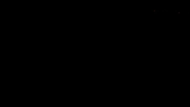 Two bright orange warning lights blinking on a dark vehicle roof at night with red glow and emergency beacon effect in low light conditions