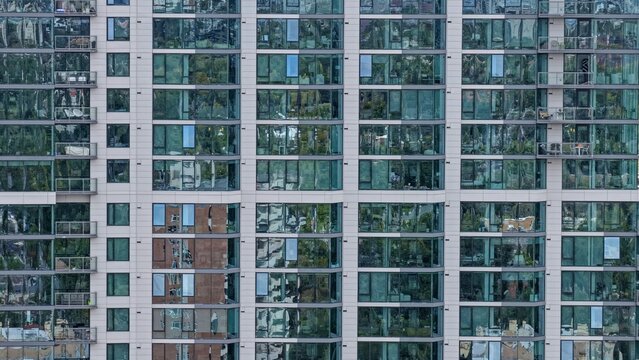 Aerial view of the modern glass facade of a high-rise building with balconies in the Cherry Creek district, Denver, Colorado, United States.