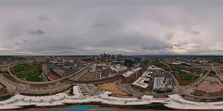 Aerial view of the Denver skyline featuring modern skyscrapers, surrounding urban infrastructure, highways, and parks in Denver, Colorado, United States.