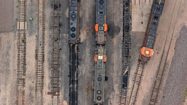 Aerial view of locomotives parked on parallel tracks at a rail yard in Denver, Colorado, United States.