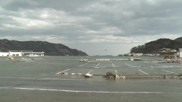 Flood Waters In Coastal Town Hit By Tsunami In Japan