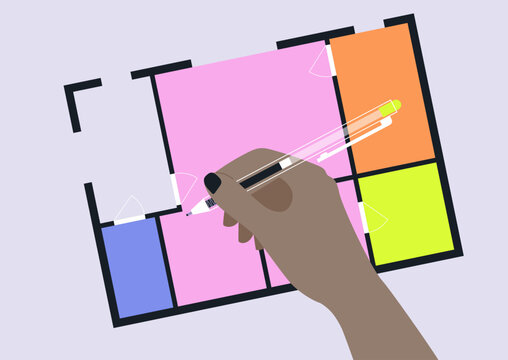 A hand editing an architectural floor plan, real estate products