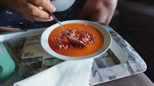 Person stirring a traditional spanish salmorejo soup