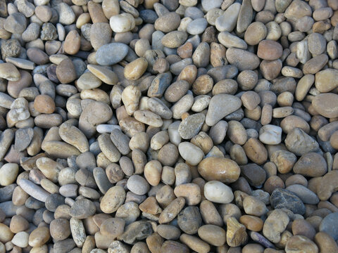 Smooth river pebbles and stones texture background.